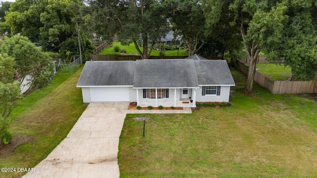 view of front of property featuring a front lawn and a garage