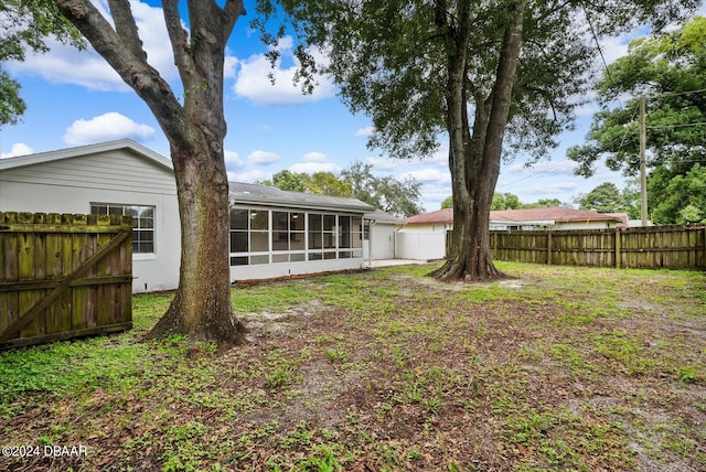 view of yard with a sunroom