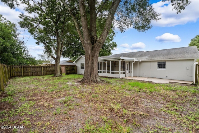 back of house featuring a sunroom and a patio area