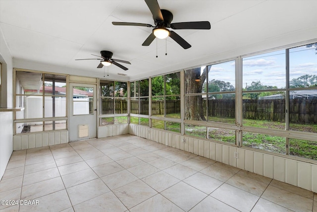 unfurnished sunroom featuring ceiling fan