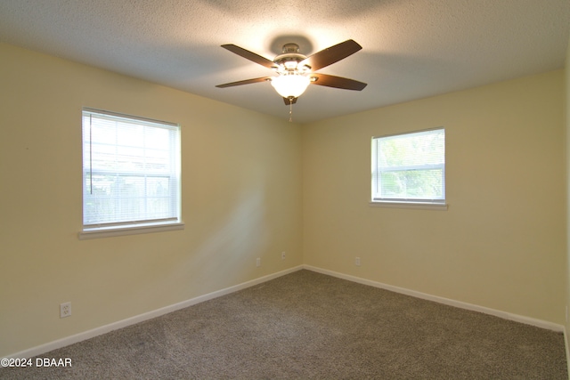 unfurnished room featuring ceiling fan, a textured ceiling, and carpet floors