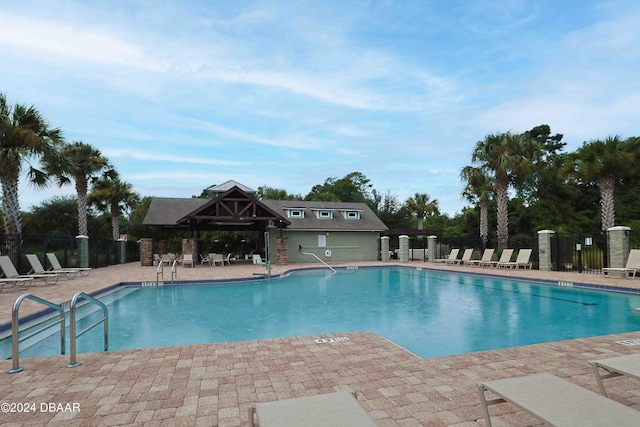 view of swimming pool featuring a patio area and a gazebo