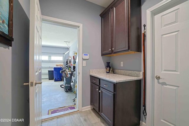 interior space with dark brown cabinetry and light hardwood / wood-style floors