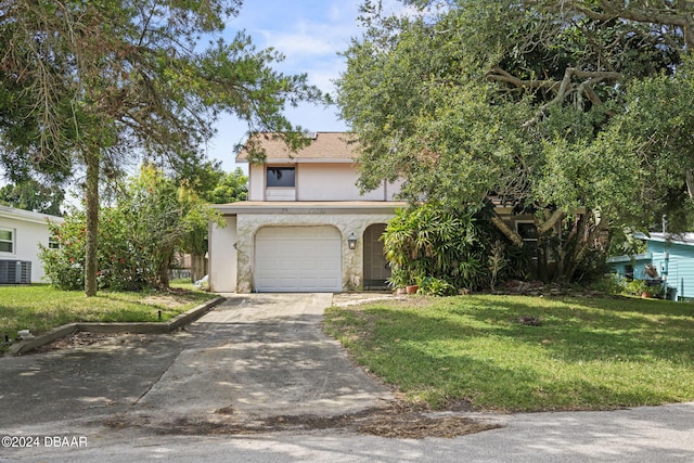 view of front of home with central AC unit, a garage, and a front yard