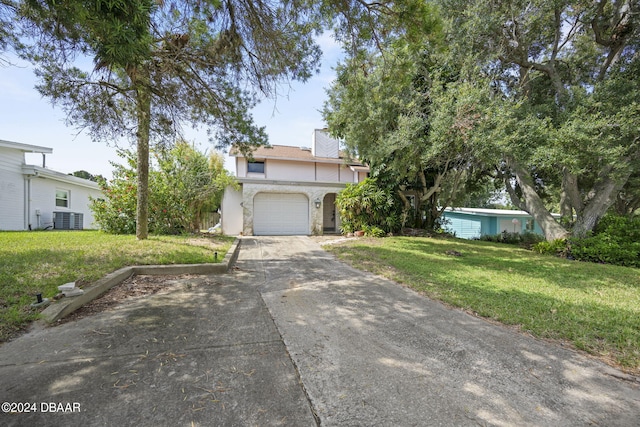 view of front of home with a garage, central air condition unit, and a front lawn