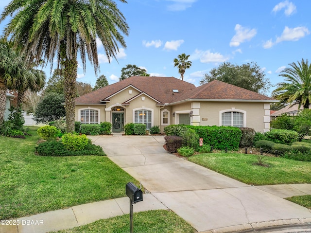 view of front of property with a garage and a front yard