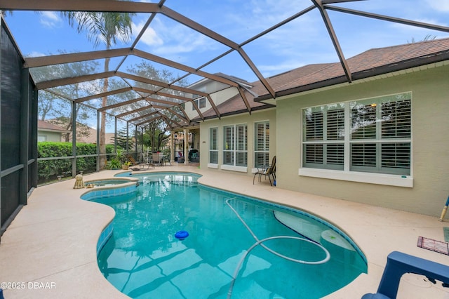 view of swimming pool featuring an in ground hot tub, glass enclosure, and a patio area