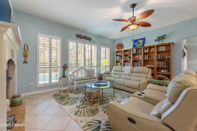 living room featuring light tile patterned floors, a textured ceiling, and ceiling fan