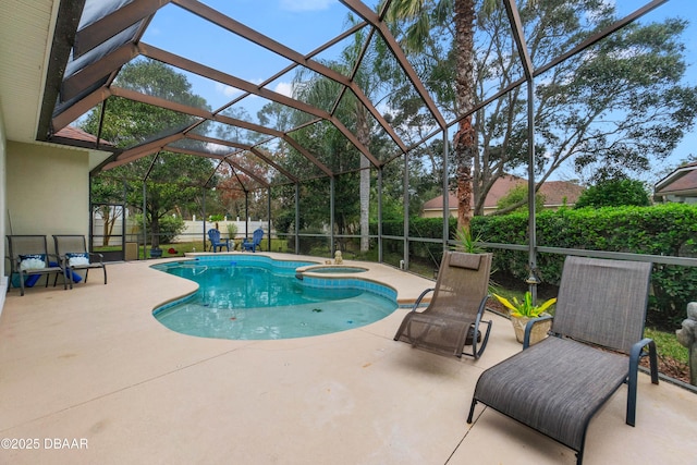 view of swimming pool with a patio area, an in ground hot tub, and glass enclosure