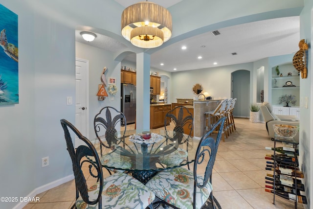 dining room featuring built in features and light tile patterned floors