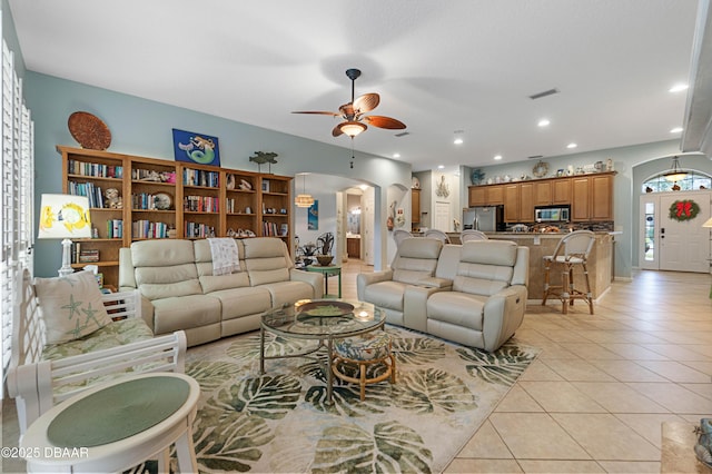 living room featuring light tile patterned flooring and ceiling fan