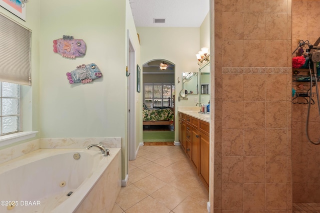 bathroom with vanity, tile patterned floors, and plus walk in shower