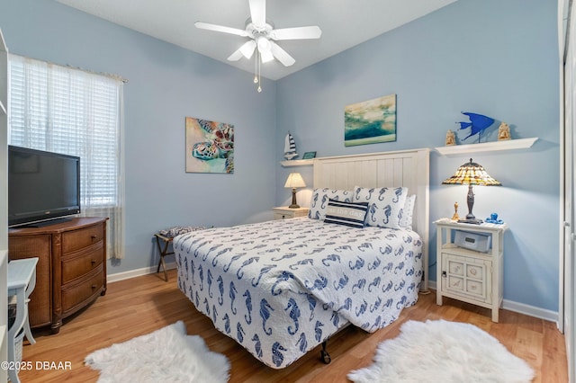 bedroom with ceiling fan and light hardwood / wood-style flooring