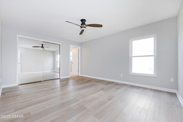 unfurnished bedroom with ceiling fan, a closet, and light hardwood / wood-style floors