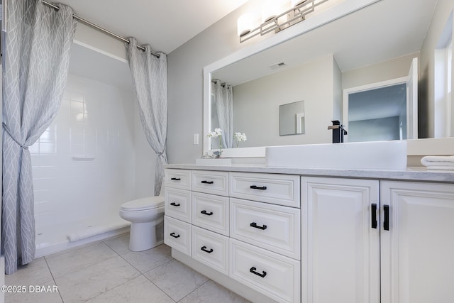 bathroom with toilet, vanity, tile patterned flooring, and a shower with curtain