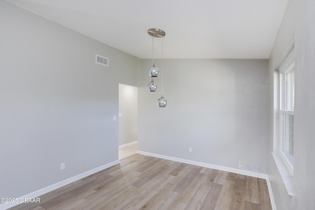 spare room featuring light wood-type flooring