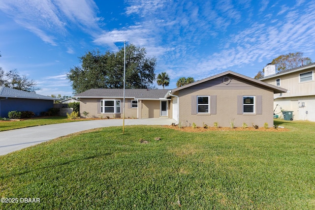 single story home featuring a front lawn