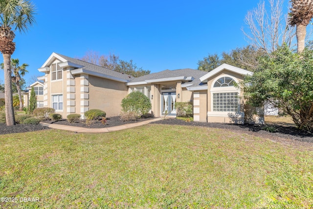 ranch-style house featuring a front yard and french doors