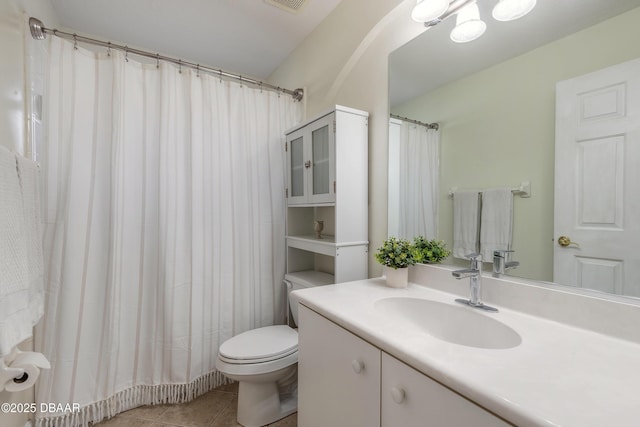 bathroom featuring tile patterned flooring, vanity, and toilet