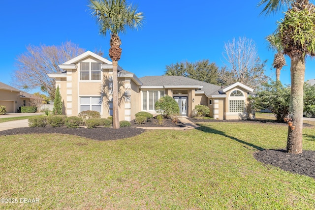 view of front facade featuring french doors and a front yard