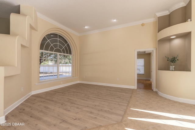 empty room with light hardwood / wood-style flooring and ornamental molding