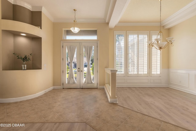 entryway featuring beam ceiling, french doors, crown molding, a chandelier, and light tile patterned floors