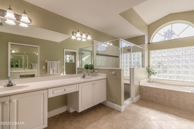 bathroom featuring tile patterned floors, vanity, lofted ceiling, and independent shower and bath