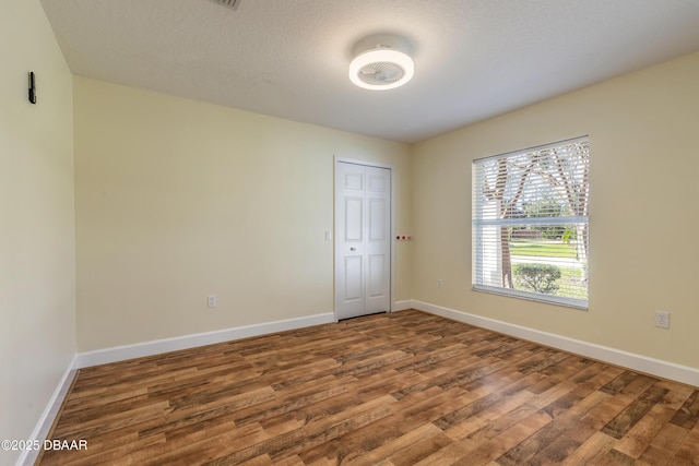 spare room with hardwood / wood-style flooring