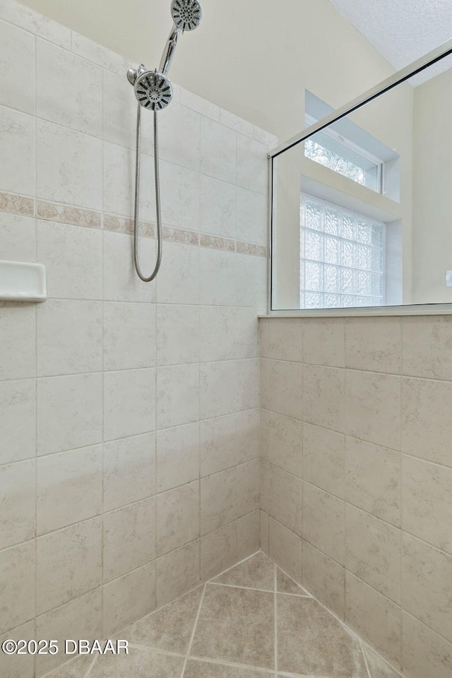 bathroom with a tile shower