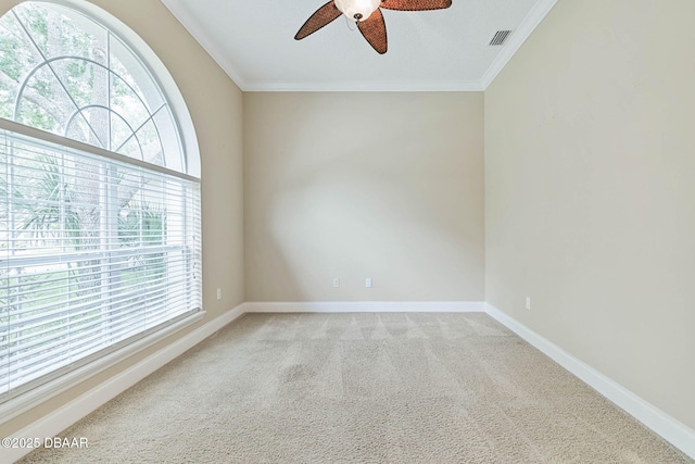 spare room with ceiling fan, crown molding, and carpet floors