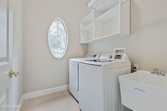 clothes washing area with sink and washer and clothes dryer