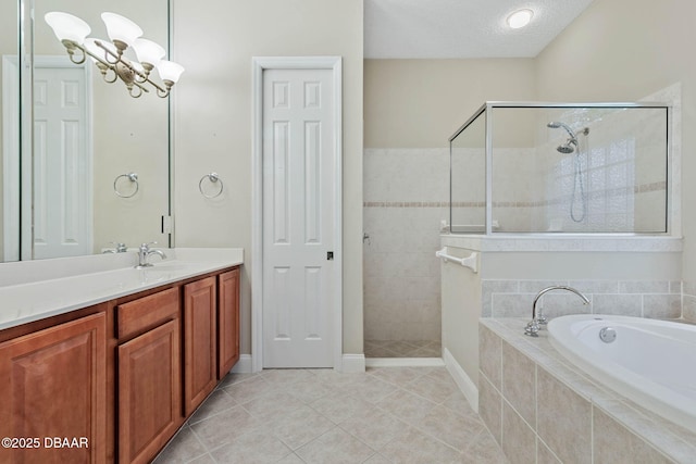 bathroom with vanity, tile patterned floors, a textured ceiling, and separate shower and tub