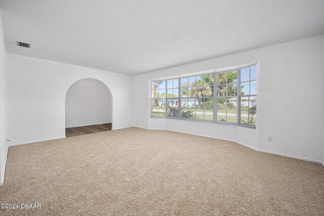 36 Dresden Cir, Ormond Beach, FL 32174 - unfurnished room with carpet floors, baseboards, and arched walkways