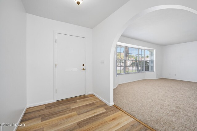36 Dresden Cir, Ormond Beach, FL 32174 - foyer entrance featuring arched walkways, baseboards, and wood finished floors