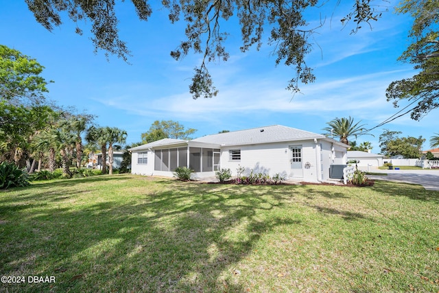 36 Dresden Cir, Ormond Beach, FL 32174 - view of side of home featuring a sunroom, a lawn, and central air condition unit