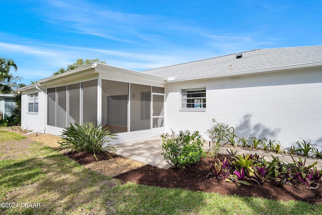 36 Dresden Cir, Ormond Beach, FL 32174 - back of property featuring a sunroom and a shingled roof