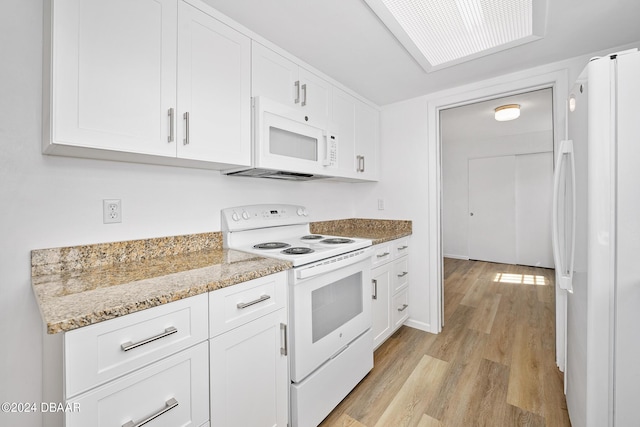 36 Dresden Cir, Ormond Beach, FL 32174 - kitchen with white appliances, light wood-style flooring, white cabinetry, and light stone countertops