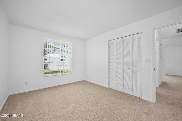 36 Dresden Cir, Ormond Beach, FL 32174 - unfurnished bedroom with carpet, a closet, and baseboards