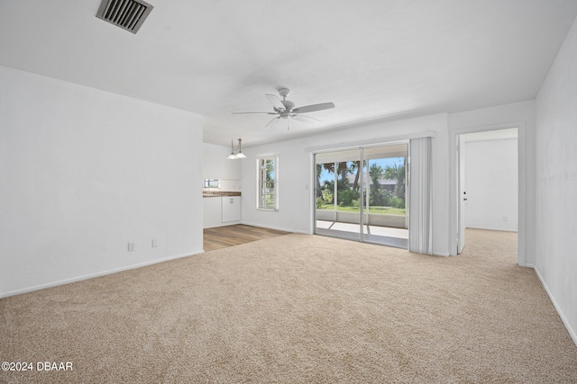 36 Dresden Cir, Ormond Beach, FL 32174 - unfurnished living room featuring carpet, a ceiling fan, and baseboards