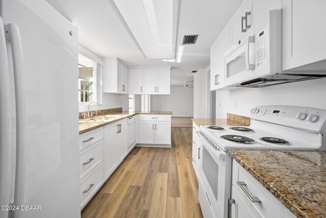 36 Dresden Cir, Ormond Beach, FL 32174 - kitchen with white appliances, a sink, light wood-style flooring, white cabinetry, and light stone countertops
