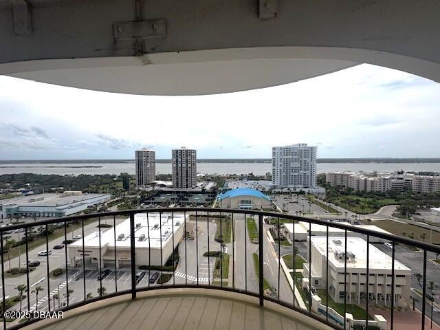 balcony with a view of city and a water view