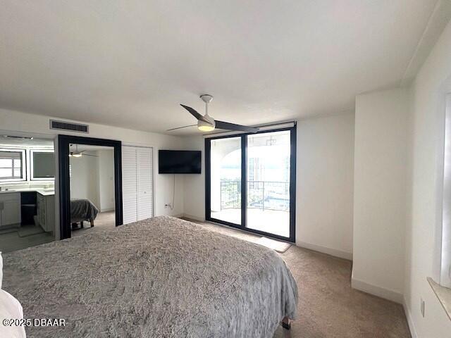 bedroom with light colored carpet, baseboards, and ceiling fan