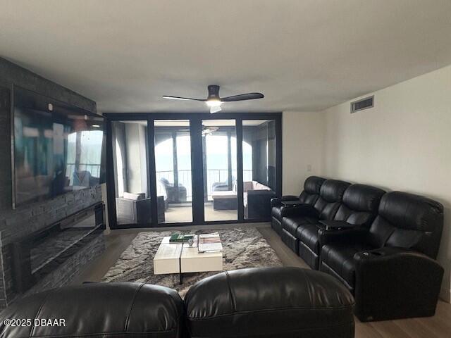 living room with wood finished floors and ceiling fan