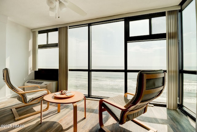 sunroom / solarium featuring ceiling fan