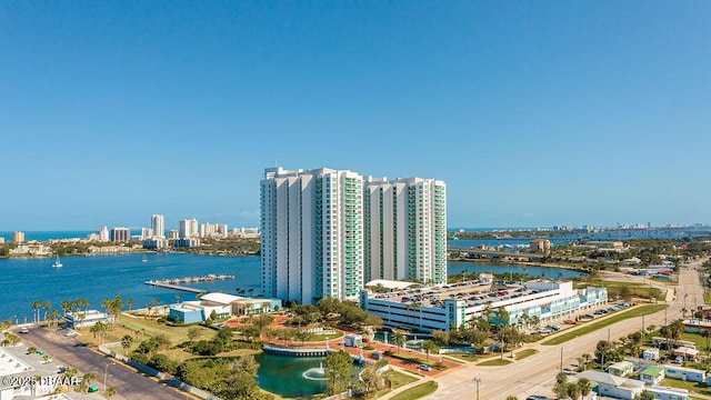 drone / aerial view featuring a view of city and a water view