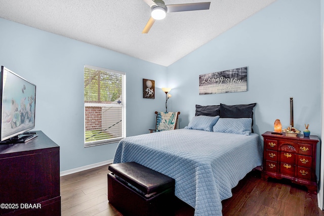bedroom featuring a textured ceiling, baseboards, vaulted ceiling, and wood finished floors