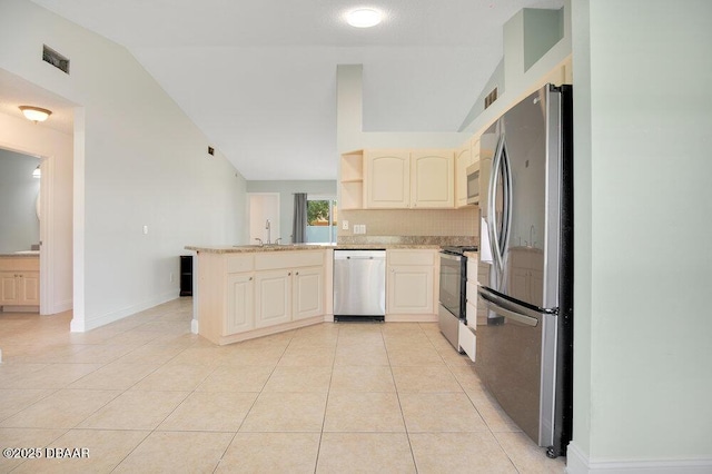 kitchen featuring lofted ceiling, sink, stainless steel appliances, light tile patterned flooring, and kitchen peninsula