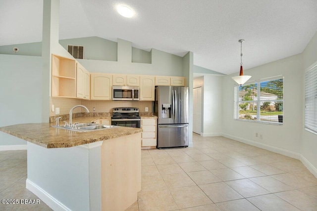 kitchen with light tile patterned flooring, sink, decorative light fixtures, appliances with stainless steel finishes, and kitchen peninsula