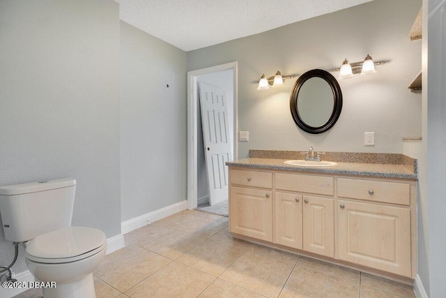 bathroom featuring vanity, a textured ceiling, tile patterned floors, and toilet