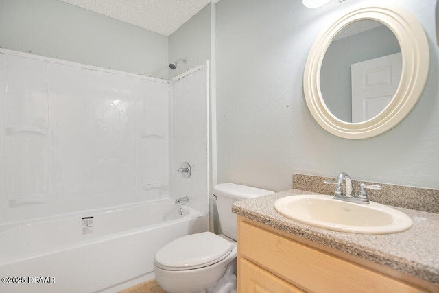 full bathroom featuring  shower combination, vanity, a textured ceiling, and toilet